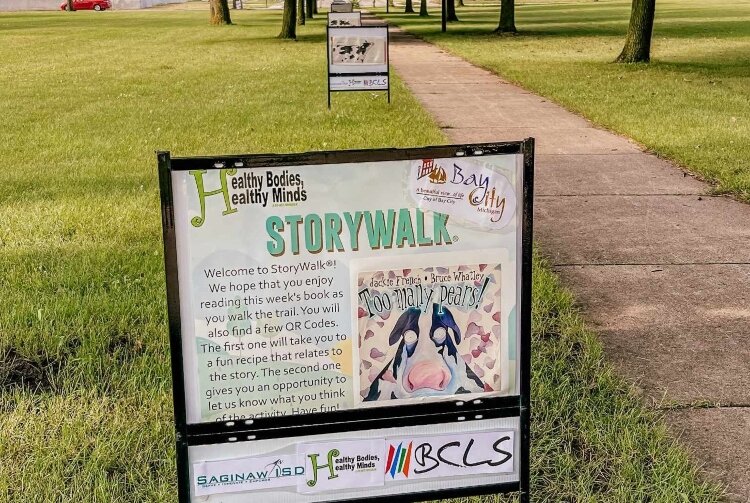 Families can enjoy a walk through a city park while reading a fun story with StoryWalks. A coalition of agencies are working together to bring fun, educational programs to Bay City parks this summer. (Photo courtesy of Bay County Library System)