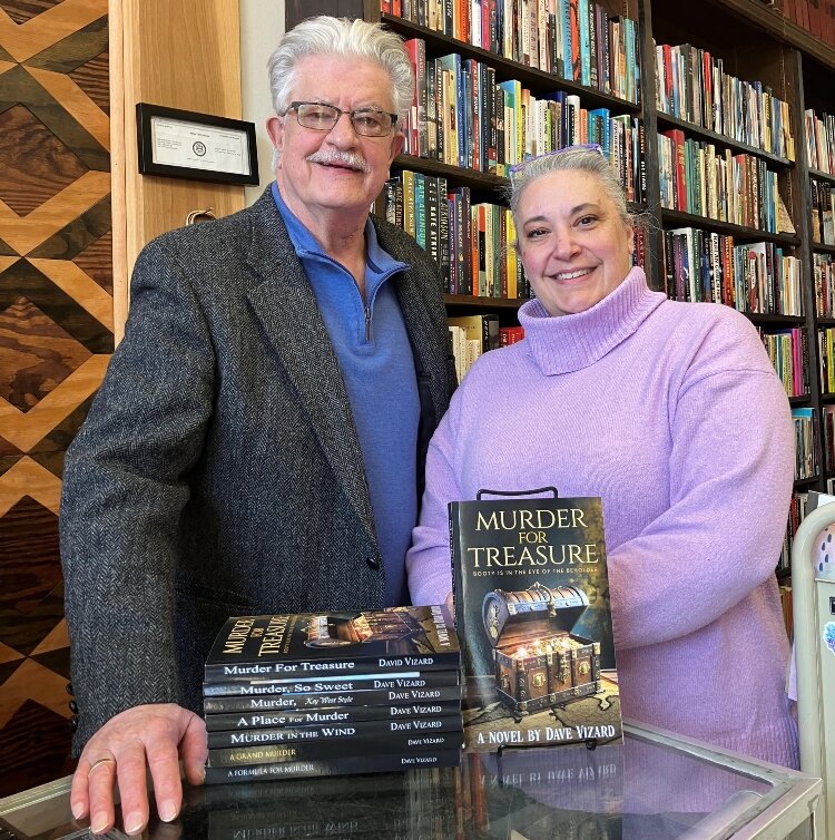 Author Dave Vizard poses with Kerice Basmadjian and his latest novel at Midland Street Books. Basmadjian and Scott Byers co-own Midland Street Books, which carries Vizard's novels. (Photo courtesy of Dave Vizard)