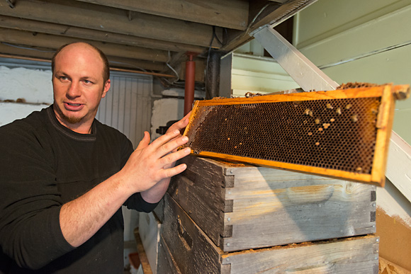 Jason Gold with a beehive frame at the Michiga
