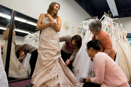 Kristen Oltersdorf trying on a wedding dress at The Brides Project Boutique