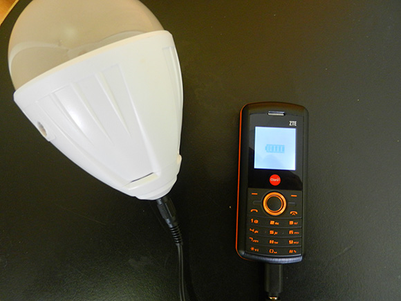 The Solar Serenity solar light charging a cell phone