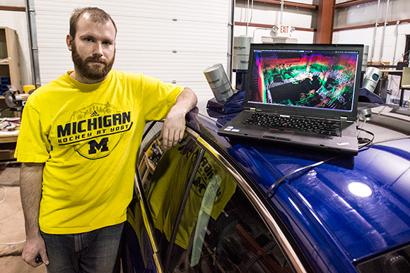 Schuyler Cohen with a Ford Fusion Hybrid Automated Next Generation Vehicle at U of M