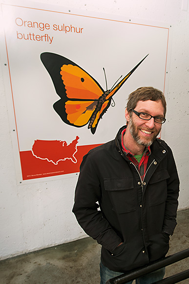 Bruce Worden with one of his art panels at the Maynard Parking Structure in Ann Arbor
