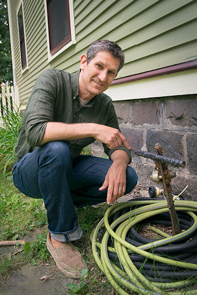 Matt Grocoff pointing out his home's disconnected gas line