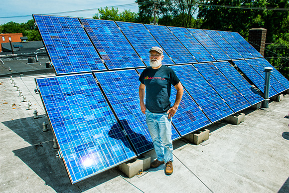 Dave Strenski with the solar panels at the Ypsilanti Food Coop