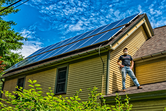 Dave Strenski with the solar panels on the roof of his house