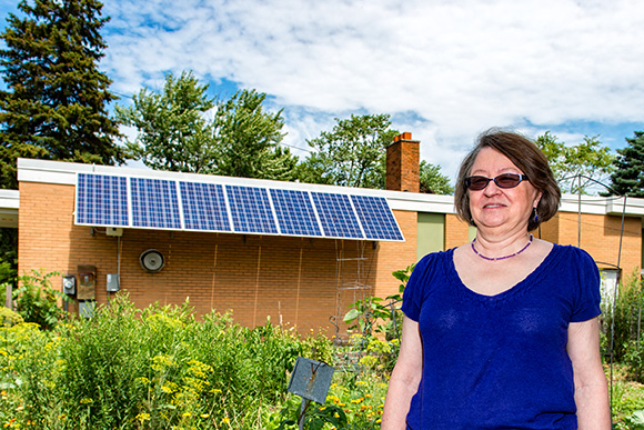 Director Monica Prince with the solar panels on the Ypsilanti Senior Center