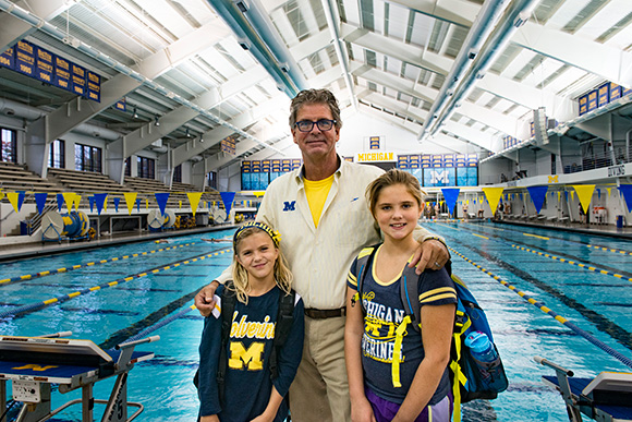 U of M head swim coach Mike Bottom with daughters Micaiah and Dublyn
