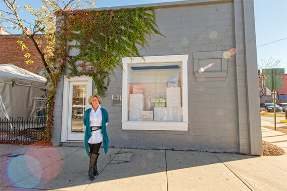 Marie Klopf in front of the Aquarium Gallery at the Ann Arbor Art Center