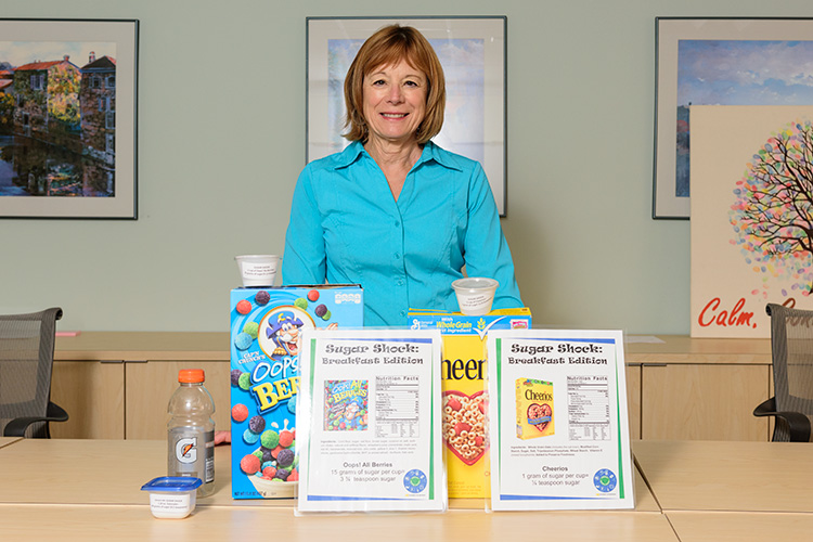 Jean DuRussell-Weston with a display of sugar amounts in popular foods