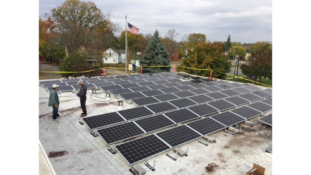 Solar panel installation in progress atop Ypsi's fire station.
