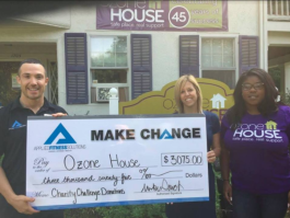 AFS founder Mike Stack presents Ozone House staff with the proceeds from AFS' charity challenge.