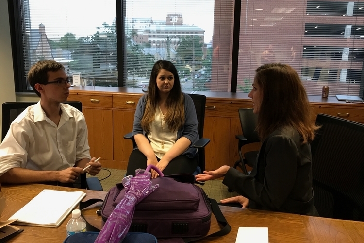 Interns Brandon Lazovic and Nina Drumsta talk with mentor-in-residence Kim Brown.
