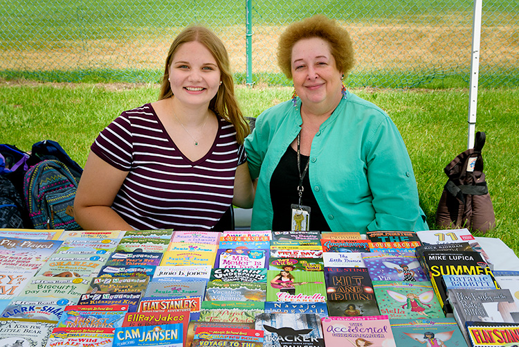 Jennifer Dixon and Kathy Wyatt with free books for kids at the Summer Playground Program