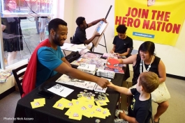 Jermaine Dickerson meets a young attendee at a Hero Nation fundraiser at Go! Ice Cream.