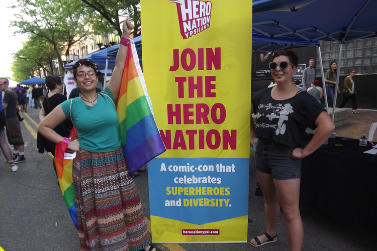 People visit the Hero Nation booth at Ypsi Pride.