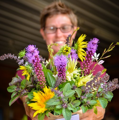 Michigan Flower Growers' Cooperative co-owner Amanda Maurmann arranges flowers. 