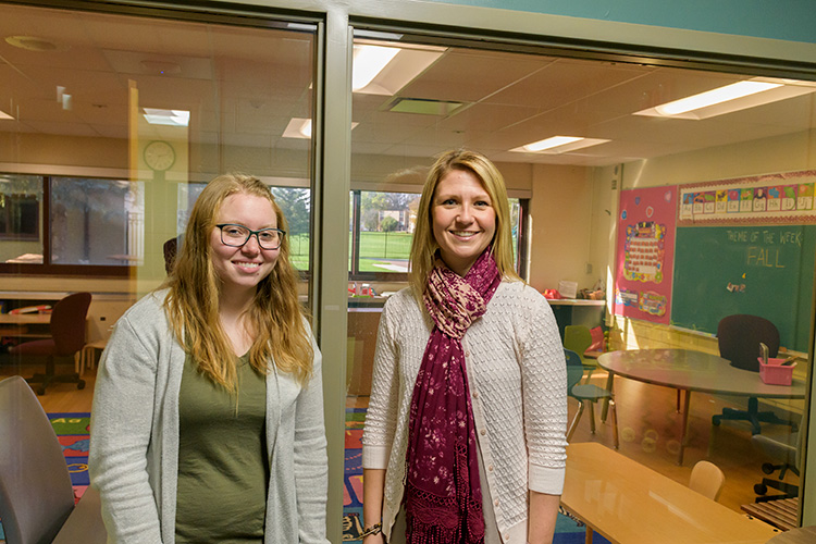 Ashley Rich and Allison Greening in an observation room at the ACC, where parents can watch their children in a classroom through a one-way mirror.