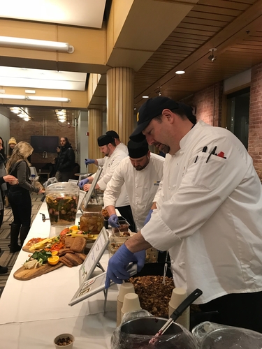 Chefs serve food at the waste dinner.