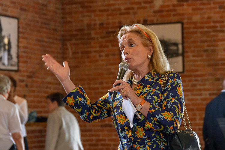 Congresswoman Debbie Dingell speaks to Bridging 23 participants at the Ypsilanti Freighthouse