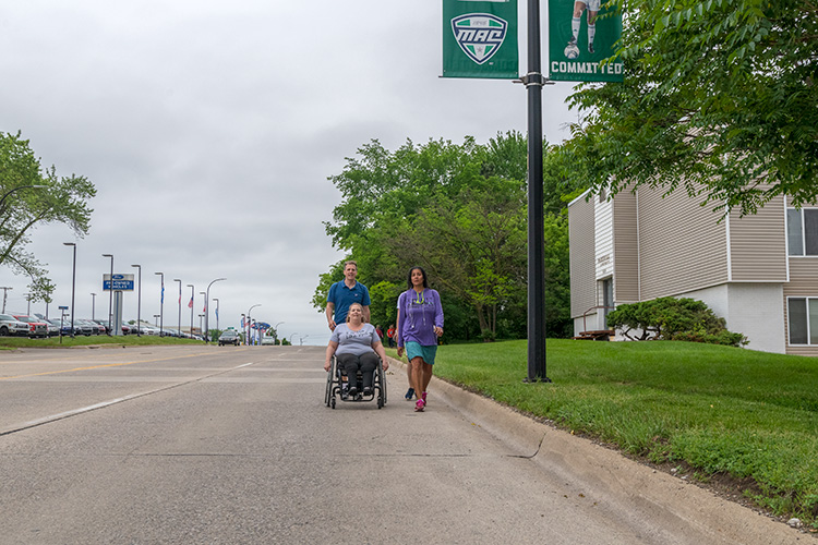 Katie Jones takes her wheelchair onto Washtenaw Avenue along one of the stretches without sidewalks