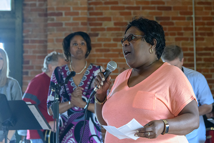 Bridging 23 organizer Robin Stephens speaks to participants at the Ypsilanti Freighthouse