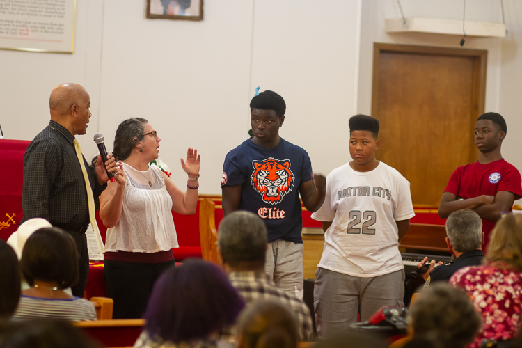 Educate Youth executive director Gail Wolkoff (white blouse) and teens who participate in the nonprofit share the story of a recent experience with an Ypsi police officer.