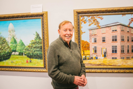 Jim Irwin with two of the paintings from his collection.