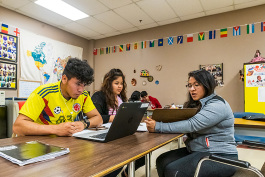 Diana Bernal-Canseco (right) of Buenos Vecinos helping students in an ESL class at YCHS.