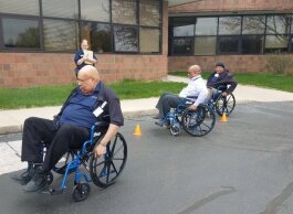 Disability Awareness Training for Transportation Agencies participants try to navigate real-world scenarios while in wheelchairs.