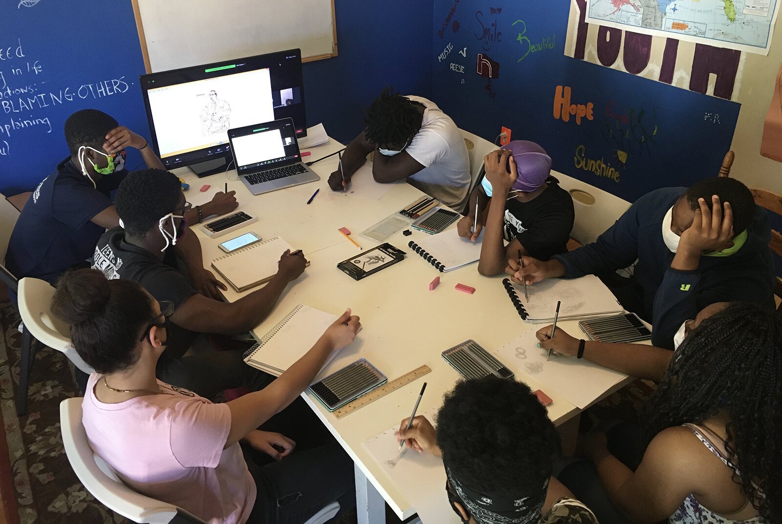 Young people participate in an art class at Educate Youth's clubhouse.