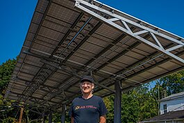 Dave Strenski in front of a solar installation at the Thompson Block in Ypsilanti.