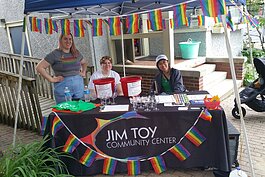 Staff work a booth outside the Jim Toy Community Center's office.