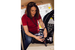 Toyota Principal Engineer Jennifer Pelky installs a car seat.
