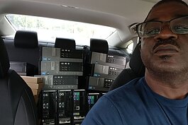Tyrone Bridges with a car load of refurbished computers to be given away.