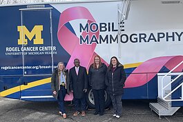 Laura Braid, Tony Denton, Lauren Esch, and Rebecca Hall with the new mobile mammography unit at the University of Michigan Ypsilanti Health Center.