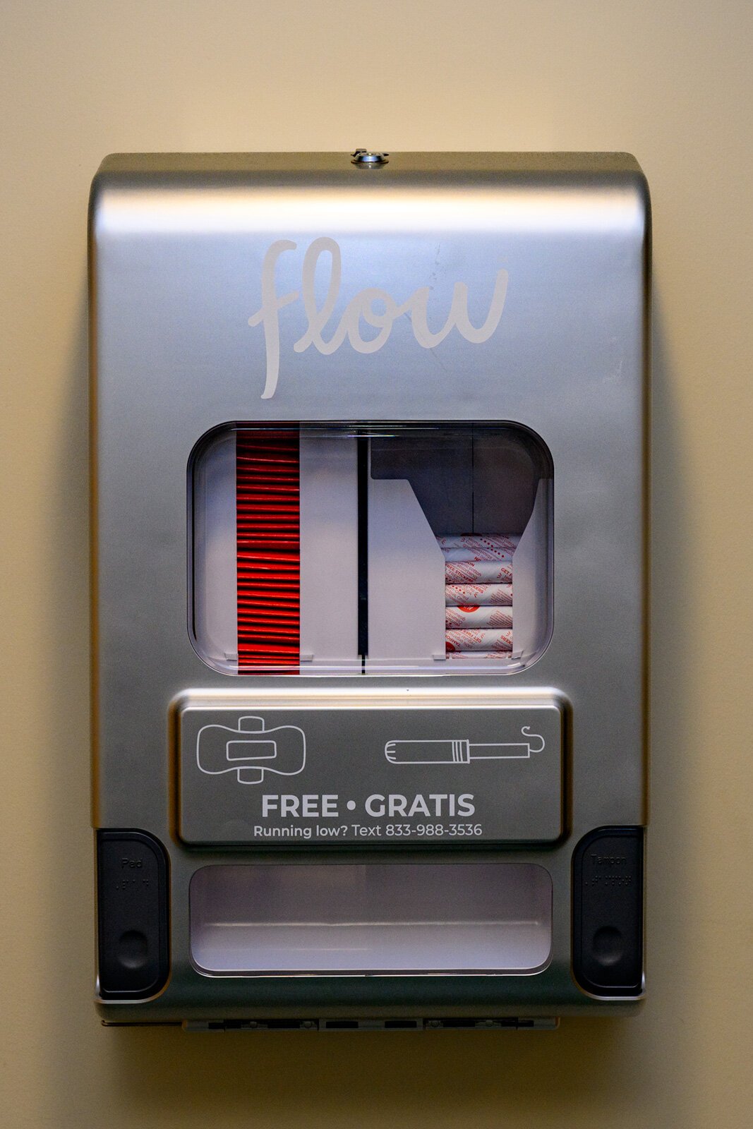 A menstrual product dispenser outside restrooms at Eastern Michigan University.