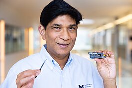 Mohammed Islam, U-M professor of electrical and computer engineering, holds technology used to detect driver impairment.