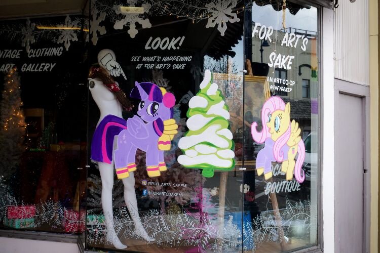 Holiday portraits of “My Little Pony” by artist Corby Blem can be seen on the windows of business For Arts Sake. Photo Credit: Courtney Jerome / Epicenter Mt. Pleasant