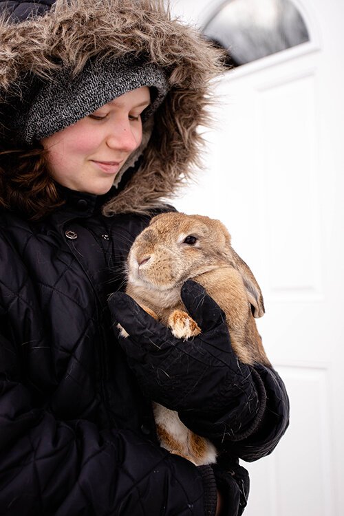Hannah Forsythe, 14, holds Peaches, one of the rabbits from HopeWell Ranch that inspired the Bunny Barn project. Peaches is a Mini Lop and will live to be eight or nine years old. 