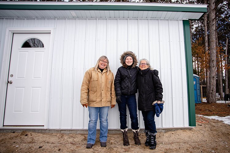 (Left to right) HopeWell Ranch Owner Jodi Stuber, Hannah Forsythe, and Miriam Forsythe stand outside of the Bunny Barn at HopeWell Ranch on Feb. 26.