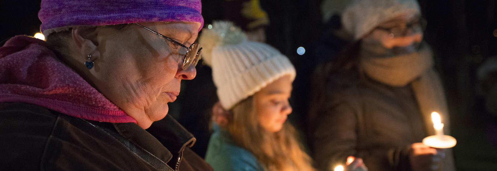 Renee Benner protects her candle from the wind at a homeless awareness event at Central Michigan University on Wednesday, Nov. 15, 2017.