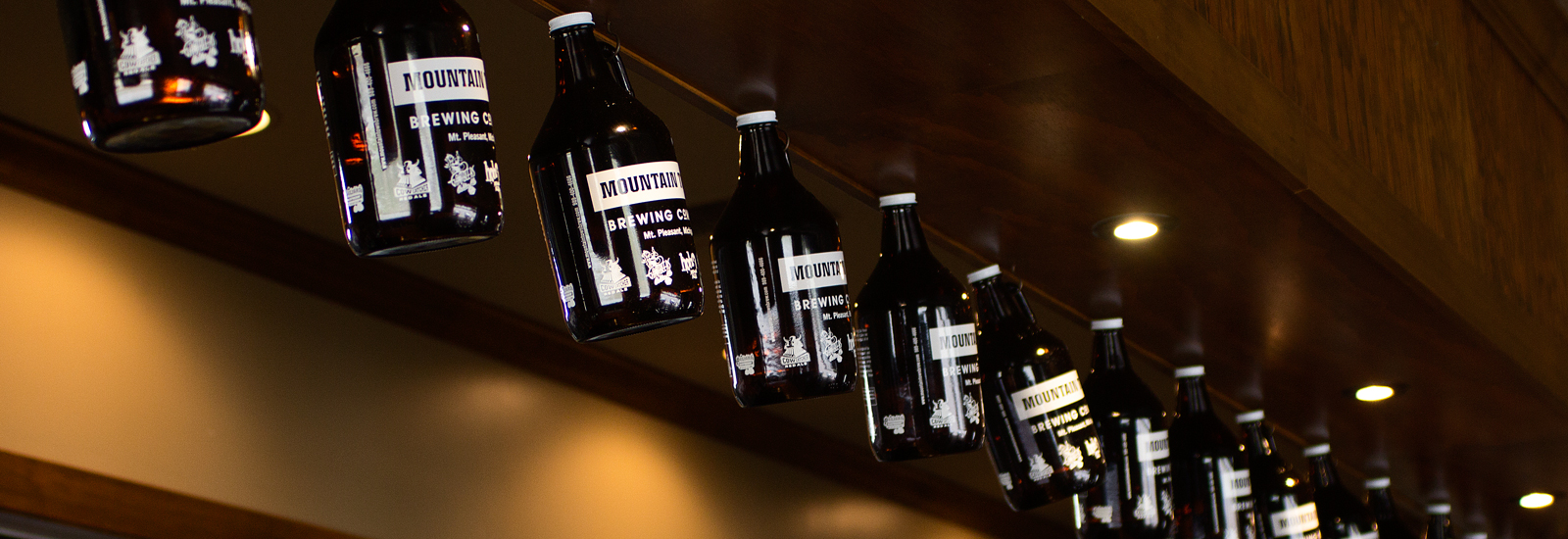 Growlers hang in the taproom at Mountain Town Brewing