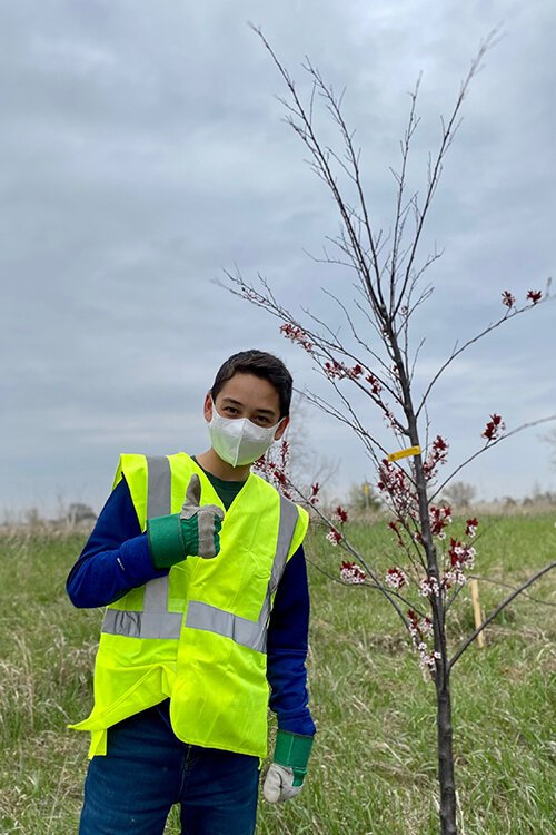 Spencer Melton, a local Boy Scout, stands along U.S. Route 127 on April 24 where he and his troops are helping to plant and mulch over 100 trees as a part of his Eagle Scout project.