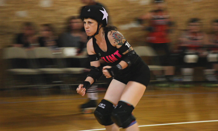 Michele Entrekin, aka Blue Velvet, smashes through the packed defenses to become the lead jammer for the Flint City Derby Girls. Entrekin is happy with her progress after about six months in the sport.