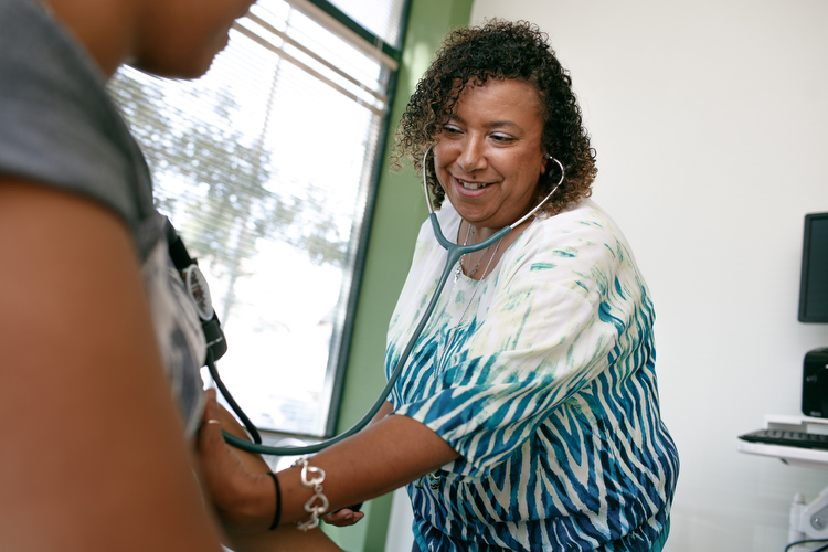 Dawn Cordero-Reyes RN checks blood pressure at the NHBP Clinic in Grand Rapids.