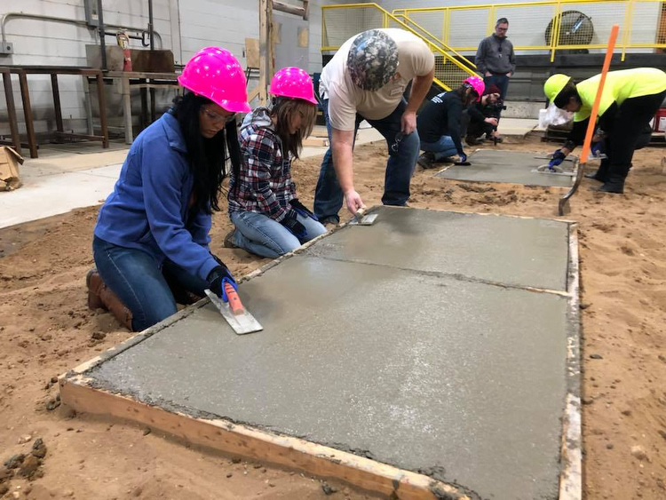 Students learn to work with concrete.
