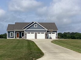 Not much question about which aspect of modern life influenced the design of this home. Garages, up front and center.