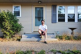 Rory Thibault in front of his Grand Haven Township home. (Courtesy)