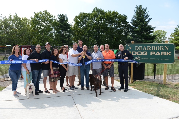 City leaders and sponsors stood in for the ceremonial ribbon cutting at the new Dearborn dog park Aug. 19. Photo by Jessica Strachan.